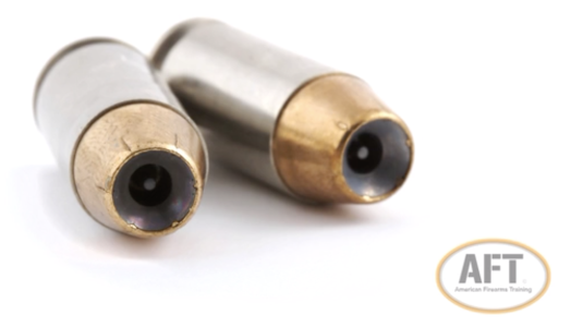 A close-up of two hollow-point bullets